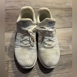 White and rose gold Nike tennis shoes